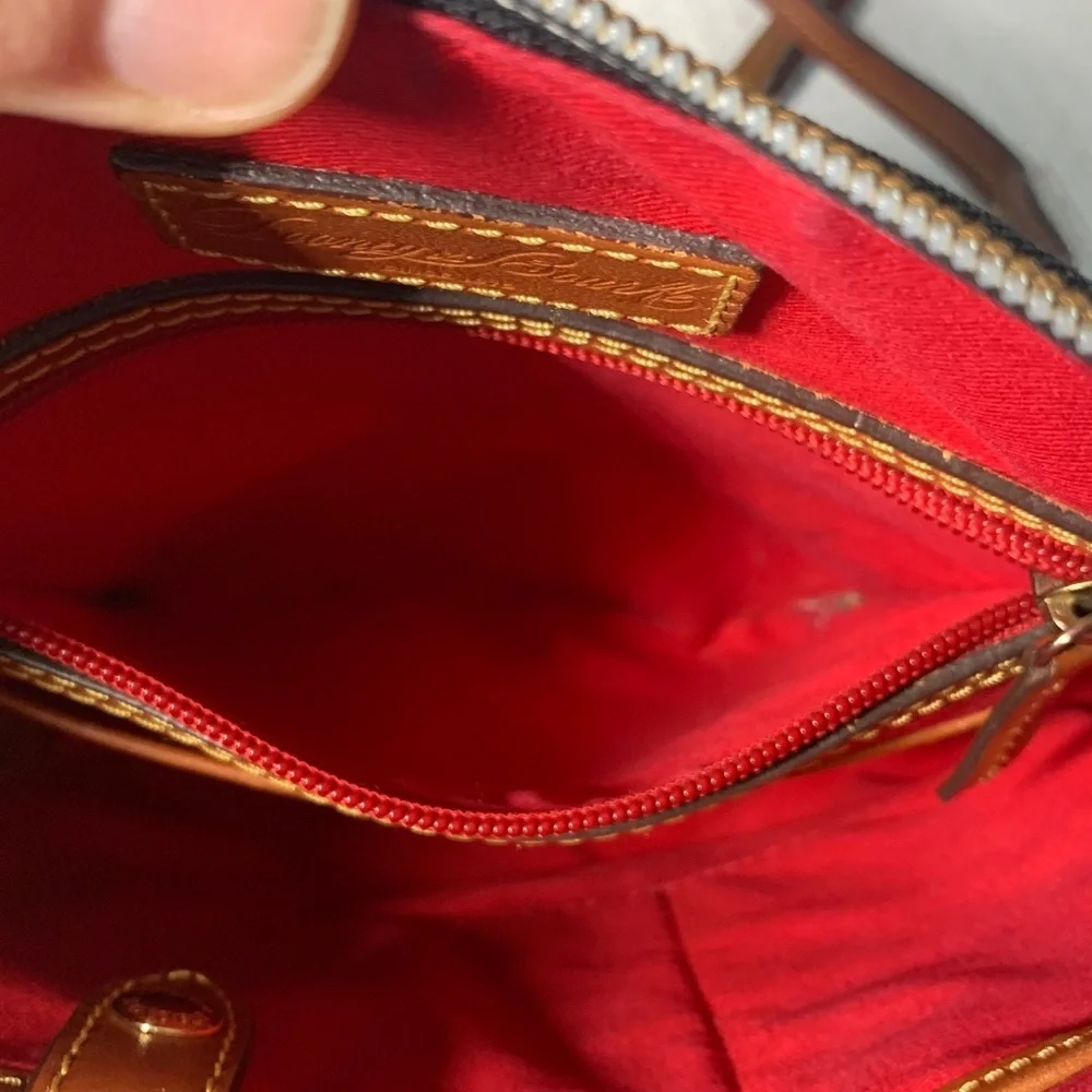 Dooney & Bourke black nylon crossbody bag with brown leather strap and accents